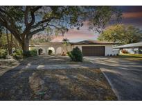 Charming single story home with mature landscaping and a two-car garage at 570 Casler Ave, Clearwater, FL 33755
