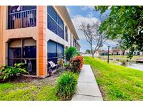 Condo building exterior with walkway, canal views, and lush landscaping at 10182 Seminole Island Dr, Largo, FL 33773