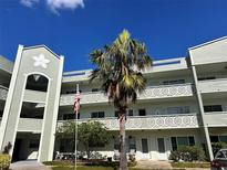 Two-story building exterior, featuring balconies and landscaping at 2256 Philippine Dr # 46, Clearwater, FL 33763