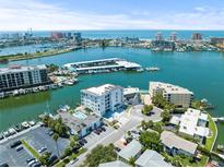 Aerial view of waterfront property with boat slips and condos at 211 Dolphin Pt # 301, Clearwater, FL 33767