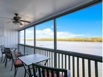 Relaxing screened balcony showcasing serene waterfront views and comfortable seating for enjoying the outdoors at 821 Bahia Del Sol Dr # 43, Ruskin, FL 33570