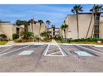 Exterior view of condo building with parking at 2205 Belleair Rd # A13, Clearwater, FL 33764