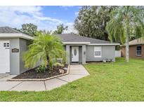 Charming single story home with gray exterior and landscaped yard at 1729 Oakwood Estates Dr, Plant City, FL 33563