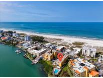 Aerial view of waterfront condo community near beach at 10301 Gulf Blvd # 402, Treasure Island, FL 33706