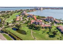 Beautiful aerial view of a golf course community with waterfront condos and lush green landscaping at 6219 Palma Del Mar S Blvd # 602, St Petersburg, FL 33715