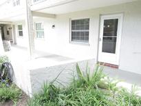 Ground floor white stucco condo with garden and patio at 940 Virginia St # 107, Dunedin, FL 34698