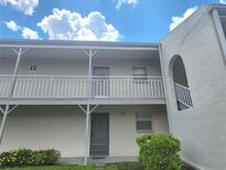 Two-story condo building with covered balconies and stairs at 2625 State Road 590 # 1523, Clearwater, FL 33759
