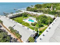Aerial view of waterfront community with pool and lush landscaping at 650 Pinellas Point S Dr # 128, St Petersburg, FL 33705