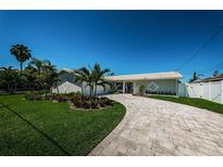 Beautiful home with a landscaped yard and paved driveway at 550 Johns Pass Ave, Madeira Beach, FL 33708