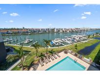 Resort-style pool and marina with multiple boats at 300 150Th Ave # 411, Madeira Beach, FL 33708