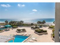 Beachfront pool area with lounge chairs and ocean views at 1380 Gulf Blvd # 307, Clearwater Beach, FL 33767