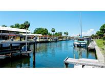 Waterfront view featuring boat docks, clear blue water, and various boats docked along the canal at 4216 La Costa Cv # 4216, Bradenton, FL 34210