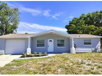 Newly renovated light gray house with white door at 3111 Fairmount Dr, Holiday, FL 34691