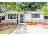 Charming single story home with a landscaped front yard and paver driveway at 166 Sw Lincoln N Cir, St Petersburg, FL 33703