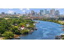 Aerial view of waterfront home with city skyline in background at 2519 N Riverside Dr, Tampa, FL 33602