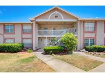 Two-story condo building with brick and light-colored exterior and lush landscaping at 6428 Gloria Dr # 15, New Port Richey, FL 34653