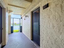 Private condo entry with screened-in porch and water view at 11485 Oakhurst Rd # 107, Largo, FL 33774