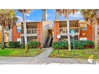 Brick condo building with lush landscaping and walkways at 9100 Dr Martin Luther King Jr N St # 1107, St Petersburg, FL 33702