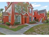 Two-story red building with landscaping and walkway at 10590 Windsor Lake Ct # 0, Tampa, FL 33626
