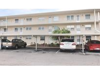Two-story condo building with covered parking and landscaping at 948 Virginia St # 205, Dunedin, FL 34698