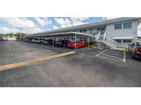 Covered parking area with cars parked in front of condo building at 5347 81St N Ln # 22, St Petersburg, FL 33709