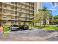 Covered parking with two cars parked under a carport at 900 Cove Cay Dr # 1H, Clearwater, FL 33760
