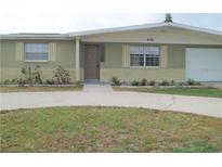House exterior, showcasing a single-story home with a driveway and landscaping at 4102 Darlington Rd, Holiday, FL 34691
