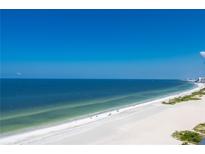 Expansive beachfront with white sand and clear blue water under a bright, cloudless sky at 1380 Gulf Blvd # 1008, Clearwater Beach, FL 33767