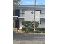 Exterior shot of apartment building shows unit D, parking, and balconies at 7580 92Nd St # 105D, Seminole, FL 33777