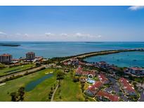 Aerial view of a waterfront community with a golf course, pool, and bridge at 6011 Bahia Del Mar Blvd # 150, St Petersburg, FL 33715
