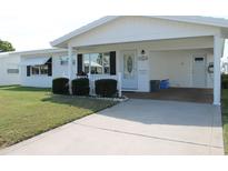 Bright white house with carport and small fence at 4251 100Th N Ave # 2, Pinellas Park, FL 33782