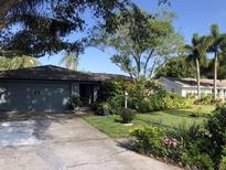 Charming single-Gathering home with a landscaped front yard and attached garage at 10366 136Th St, Largo, FL 33774