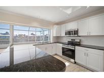 Modern kitchen with stainless steel appliances and granite countertops at 910 Spindle Palm Way, Apollo Beach, FL 33572