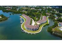 Beautiful aerial view of waterfront community with boat docks and lush landscaping on a sunny day at 129 Brent Cir, Oldsmar, FL 34677