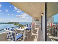 Enjoy serene waterfront views from this condo's balcony, complete with dining set and comfortable seating at 6035 Sea Ranch Dr # 505, Hudson, FL 34667