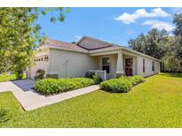 One-story house with front porch and lush landscaping at 4316 Old Waverly Ct, Wesley Chapel, FL 33543