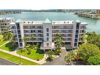 Aerial view of waterfront condo building with lush landscaping at 8001 Sailboat Key S Blvd # 204, St Pete Beach, FL 33707