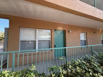 Exterior view of condo building with green door at 5816 Congress St # 104, New Port Richey, FL 34653