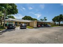 Condo building with covered parking and lush landscaping at 2465 Northside Dr # 702, Clearwater, FL 33761