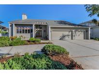 Inviting single-story home featuring a spacious driveway and beautiful landscaping at 526 Belle Isle Ave, Belleair Beach, FL 33786