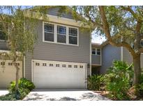 Charming two-story home with a two-car garage and beautifully landscaped front yard at 2848 Bayshore Trails Dr, Tampa, FL 33611
