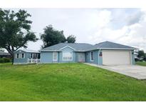 Charming house with attached garage and large yard at 7267 Teaberry St, Englewood, FL 34224