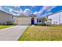 Charming one-story house with two-car garage and landscaped lawn at 30964 Penny Surf Loop, Wesley Chapel, FL 33545