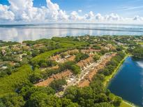 Aerial view of a waterfront community with lush landscaping and private lake at 3051 Overlook Pl, Clearwater, FL 33760