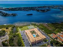 Aerial view of waterfront condo community with pool and tennis courts at 12760 Indian Rocks Rd # 1036, Largo, FL 33774
