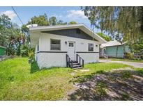 Quaint one-story home with a white exterior and gray accents at 1616 18Th Street E Ct, Palmetto, FL 34221