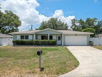 Charming ranch house with a well-manicured lawn and driveway at 2347 Eastwood Dr, Clearwater, FL 33765