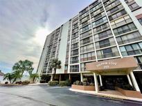 Dolphin Cove building exterior, with parking and landscaping at 255 Dolphin Pt # 809, Clearwater, FL 33767