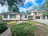 Two story home with attached garage and landscaping at 2811 Valencia S Way, St Petersburg, FL 33705