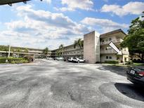 Two-story apartment building with ample parking and landscaping at 5750 80Th N St # C108, St Petersburg, FL 33709